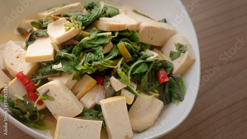 stir fried tofu with basil leaves - close up shot