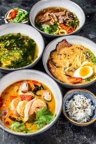 Fototapeta Naklejka Na Ścianę i Meble -  Assorted traditional Asian soups. Miso, Ramen, Tom Yam, Pho Bo. Black background. Top view
