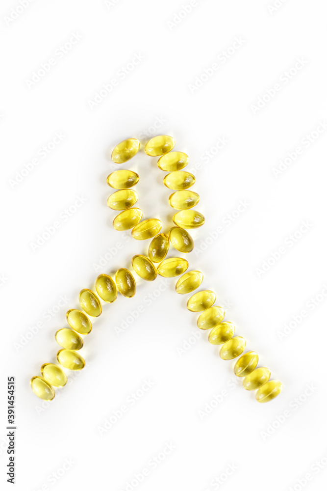 symbolic tape of fish oil capsules on a white background, yellow tape verical symbolic tape of fish oil capsules on a white background, yellow tape verical