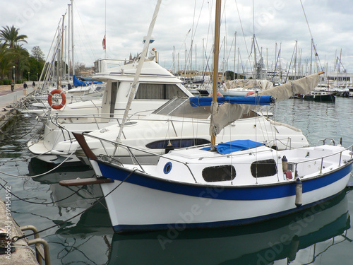 Boats in a yacht club in the Mediterranean sea, island of Mallorca, Spain. Yachts moored in the port on a cloudy day.