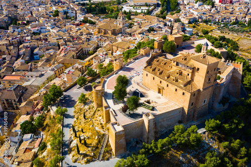 Panoramic aerial view of Caravaca de la Cruz cityscape overlooking medieval fortress and basilica, Murcia, Spain.. photo