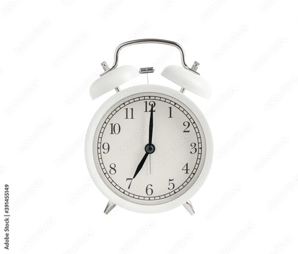 White alarm clock with black hands of a watch showing seven hours isolated or cut out on white background White alarm clock with black hands of a watch showing seven hours isolated or cut out on white background