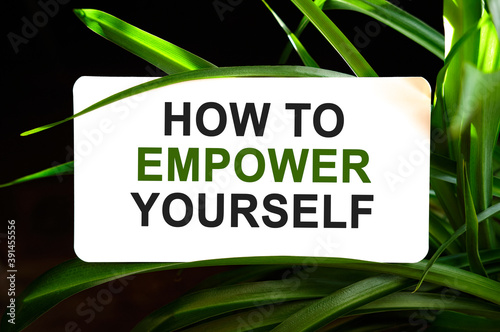HOW TO EMPOWER YOURSELF text on white surrounded by green leaves