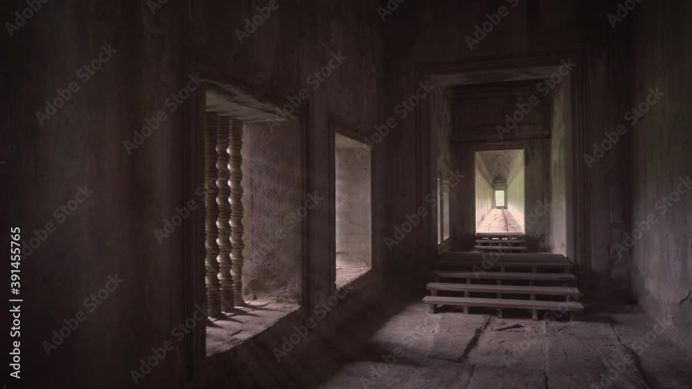 Glowing sun light rays entering windows in the galleries of Angkor Wat, Cambodia Glowing sun light rays entering windows in the galleries of Angkor Wat, Cambodia