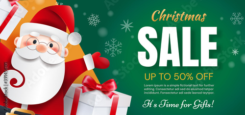Santa Claus with gifts announces holiday discounts. Christmas sale time for gifts.
