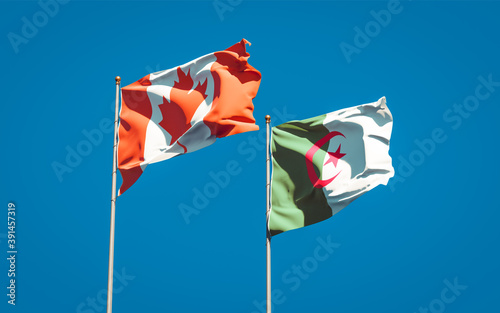 Beautiful national state flags of Algeria and Canada together at the sky background. 3D artwork concept.