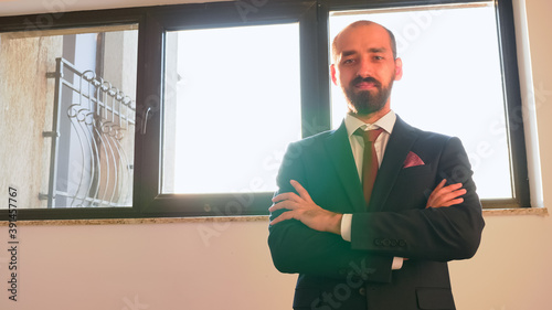 Portrait of employee looking on camera with smiling face satisfied with good job career posing in modern business office. Entrepreneur, manager, office executive standing on stairs corporate building photo