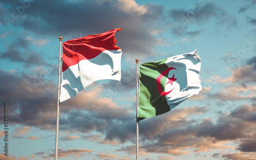 Beautiful national state flags of Monaco and Algeria together at the sky background. 3D artwork concept. © Leo Altman