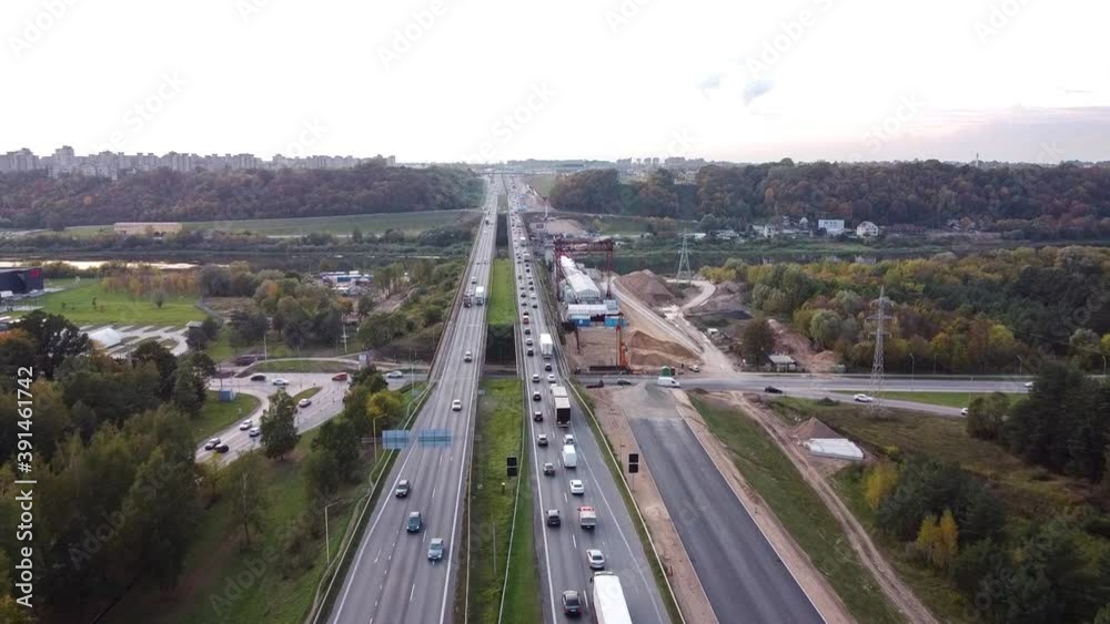 The A1 highway bridge over river Neris in Kaunas, Lithuania in drone aerial flying forwad shot. Heavy traffic. The A1 highway bridge over river Neris in Kaunas, Lithuania in drone aerial flying forwad shot. Heavy traffic.