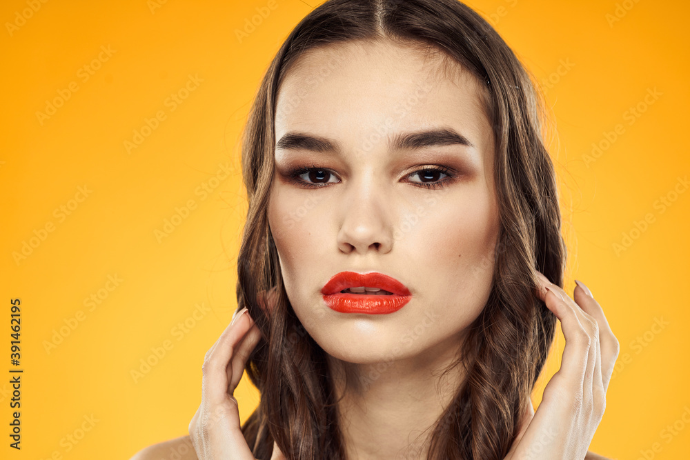 Woman with bare shoulders red cropped lips charm yellow background Woman with bare shoulders red cropped lips charm yellow background