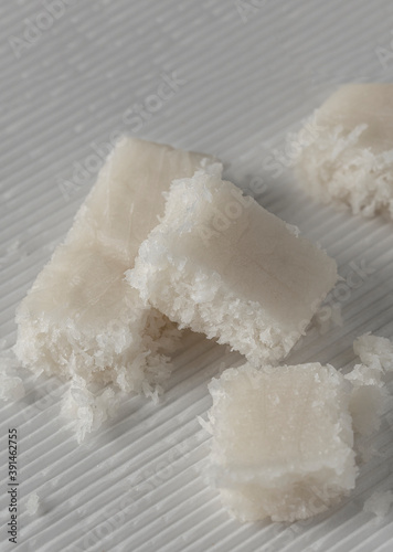 Close up of  Coconut Nougat or Turron de coco  on white background with Christmas decoration.
