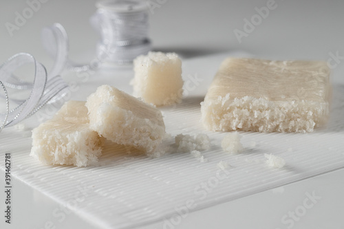 Artisan Coconut Nougat or Turron de coco  on white background with Christmas decoration.