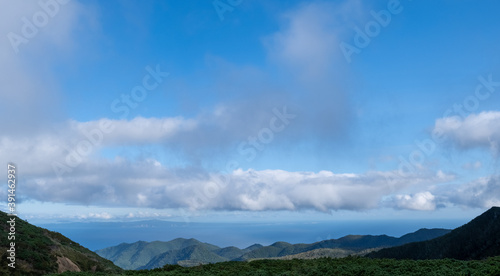 View of cloudy mountain ranges by Lake Rausu