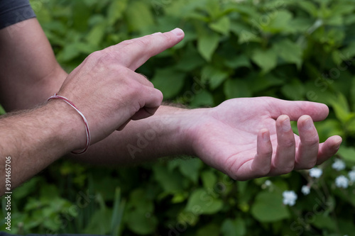 Close up of hands touching, EFT tapping therapy technique.