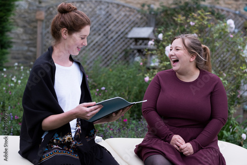 A woman and a therapist talking in a garden.  photo