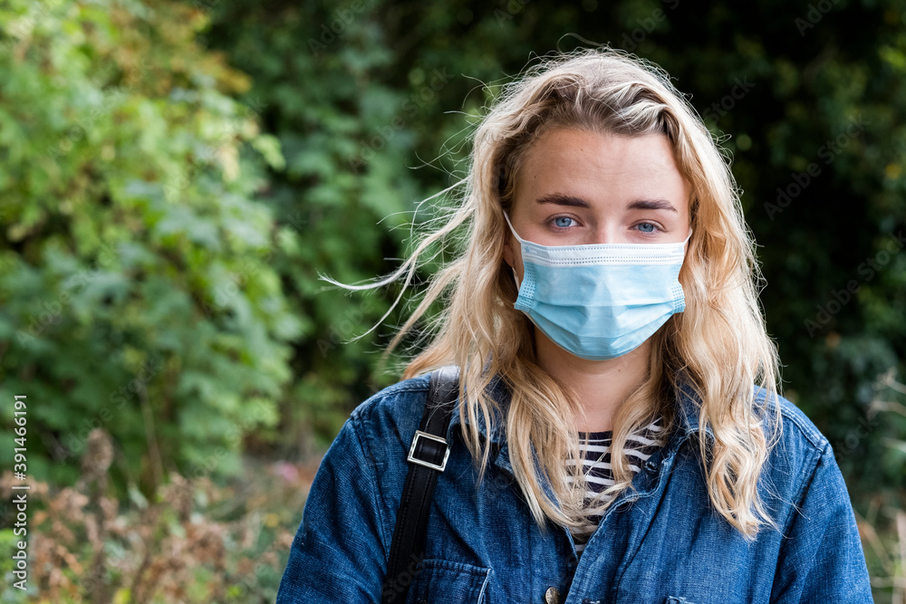 Portrait of young blond woman wearing face mask, looking at camera. Portrait of young blond woman wearing face mask, looking at camera.