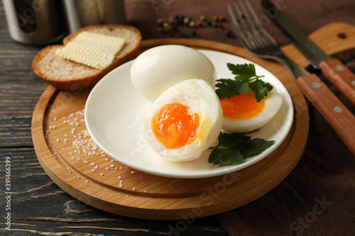 Concept of breakfast with boiled eggs on wooden background