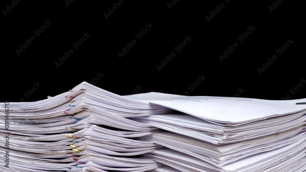 Stop motion animation Stacks overload document paper files rotation on office desk isolated on black background, Business concept, Close up.