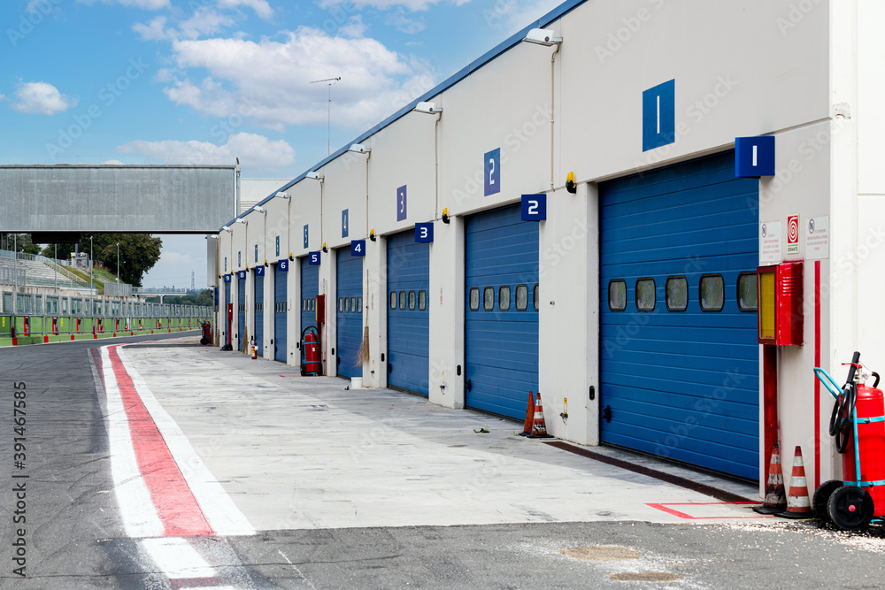 Motor sport circuit asphalt track pit lane with closed box aligned Motor sport circuit asphalt track pit lane with closed box aligned