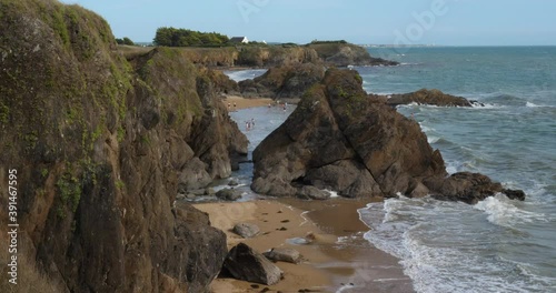 Le Pouldu, Finistere department, Brittany, France. Rocks overlooking the Kerou beach suring the low tide. photo