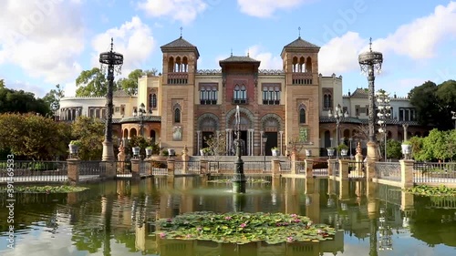 fountain in the park with a beautiful building like a palace - Seville in Spain