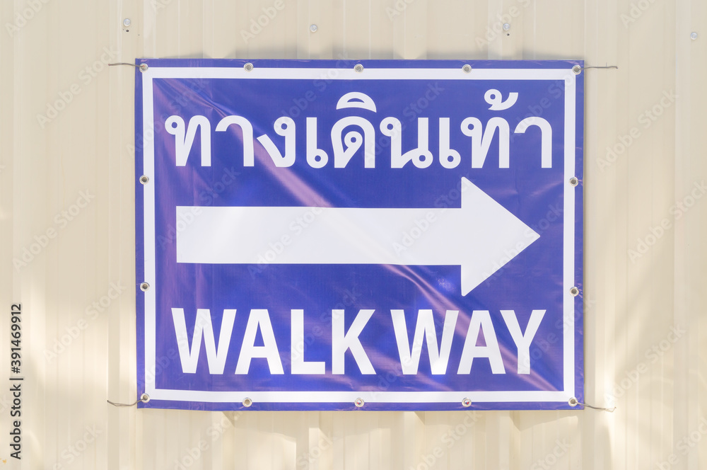 blue walk way sign with arrow on it at a subway construction site in Bangkok of Thailand