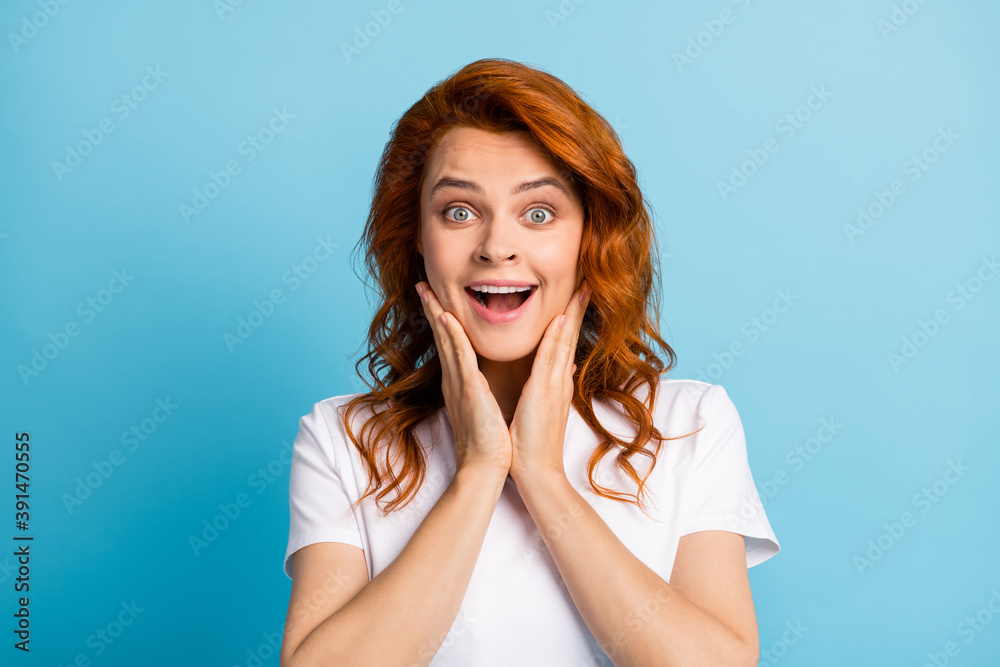 Photo portrait of shocked woman touching face cheeks with two hands isolated on pastel blue colored background Photo portrait of shocked woman touching face cheeks with two hands isolated on pastel blue colored background