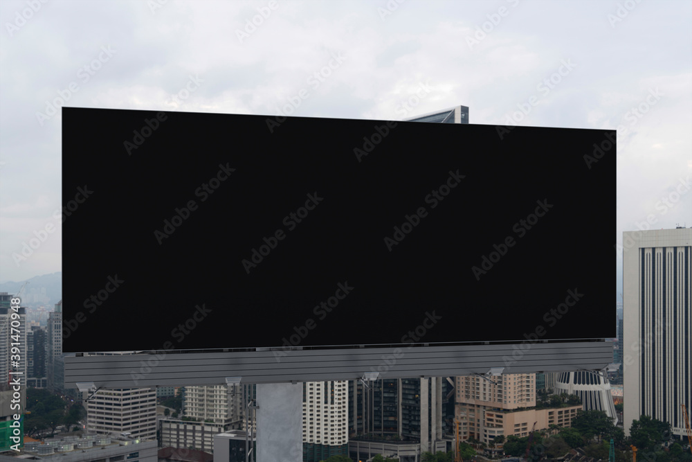Blank black road billboard with Kuala Lumpur cityscape background at day time. Street advertising poster, mock up, 3D rendering. Front view. Concept of marketing to promote or sell services or ideas. Blank black road billboard with Kuala Lumpur cityscape background at day time. Street advertising poster, mock up, 3D rendering. Front view. Concept of marketing to promote or sell services or ideas.