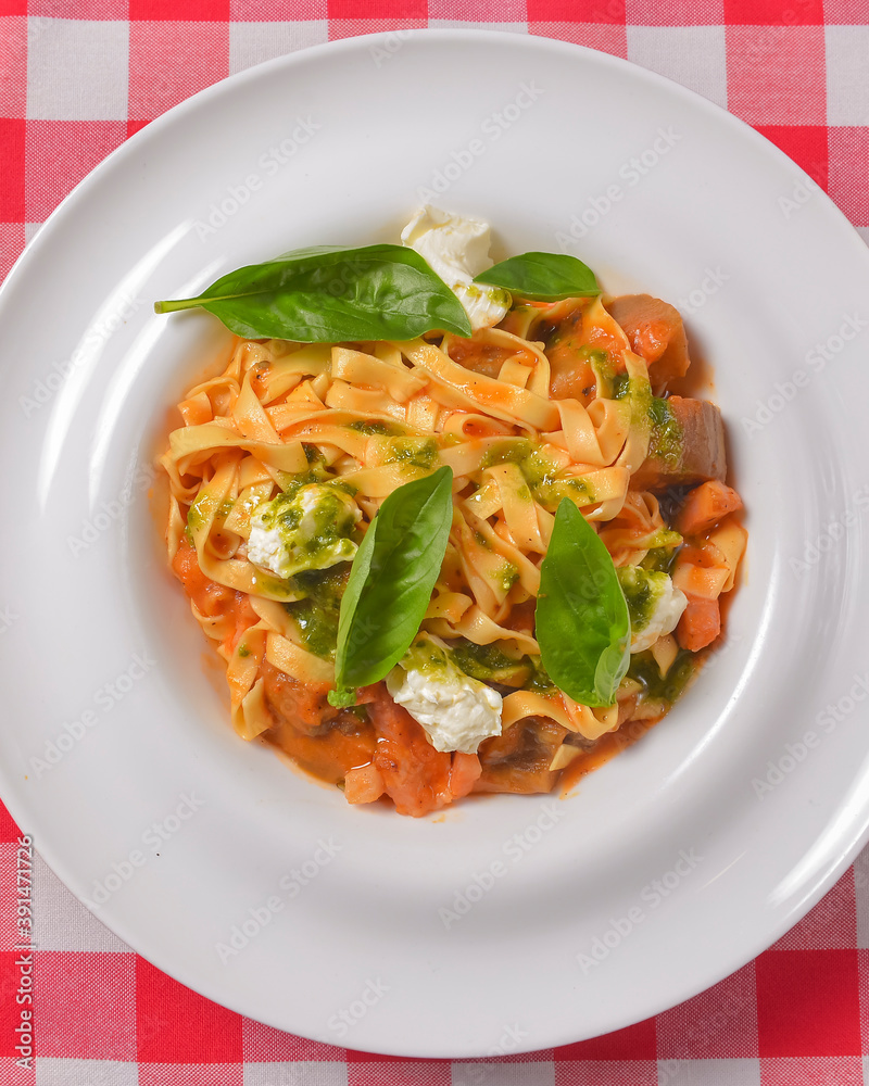 Italian penne pasta or noodles with a savory tomato sauce, fresh basil and grated parmesan cheese.