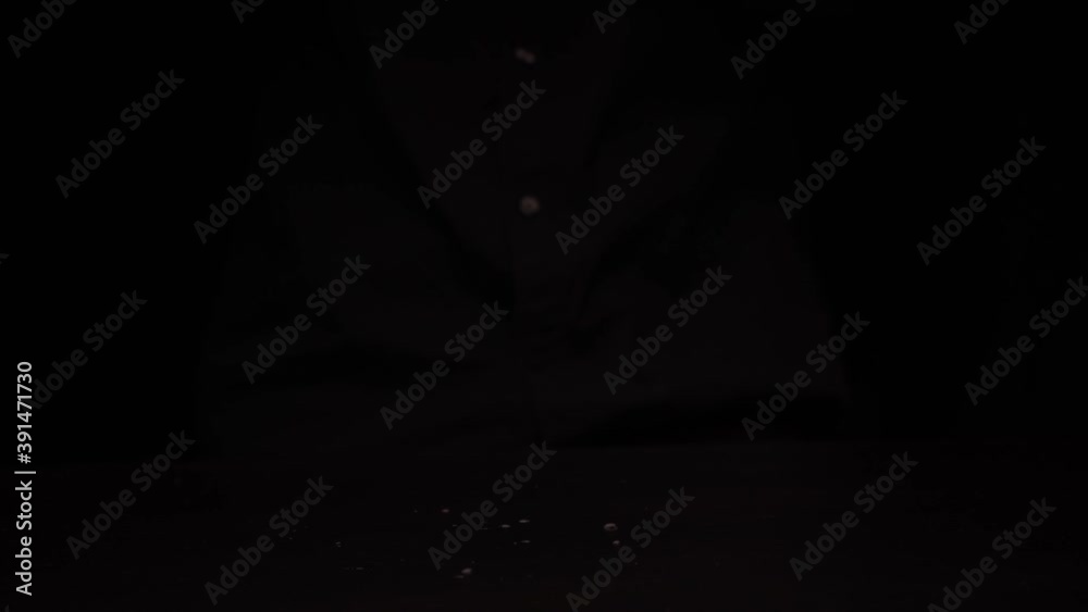 Men's hands offer to hold fresh red bell pepper on a dark background Men's hands offer to hold fresh red bell pepper on a dark background