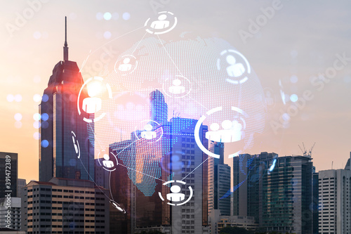 Photography Hologram of social media icons over sunset panoramic cityscape of Kuala Lumpur, Malaysia, Asia