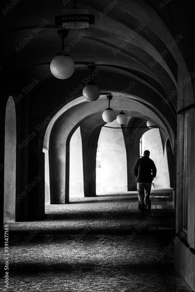 Silhouette Of A Man Walking Through A Dark Archway In Prague Silhouette Of A Man Walking Through A Dark Archway In Prague