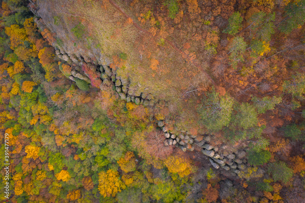 Kisapati, Hungary - Aerial view of volcanic basalt organs at Szent Gyorgy-hegy near lake Balaton with moody tones and warm autumn colored trees.