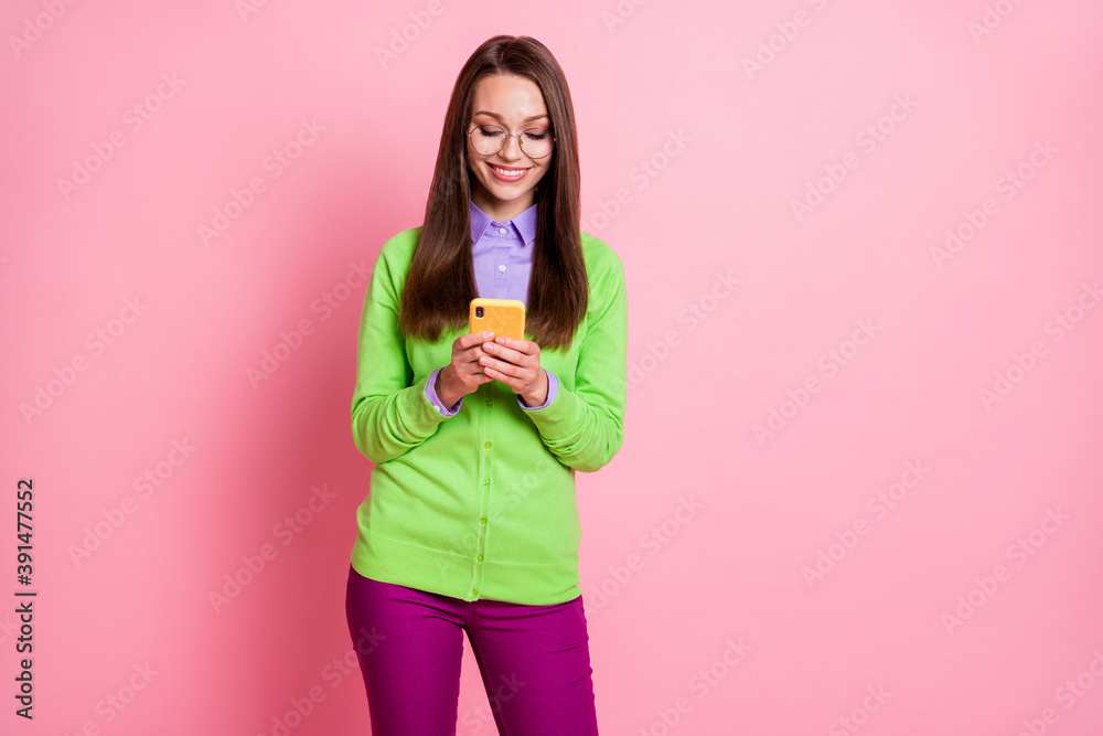 Photo of positive cheerful girl use smart phone wear green purple pants trousers isolated pastel color background Photo of positive cheerful girl use smart phone wear green purple pants trousers isolated pastel color background