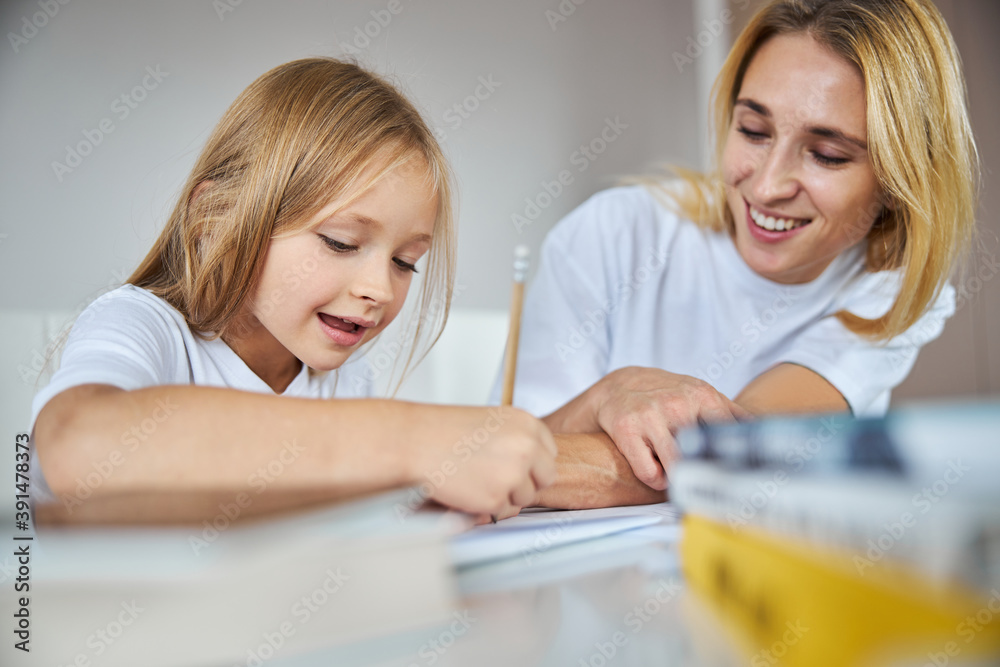 Charming miss with her mother enjoying good time at the weekend while spending time together Charming miss with her mother enjoying good time at the weekend while spending time together