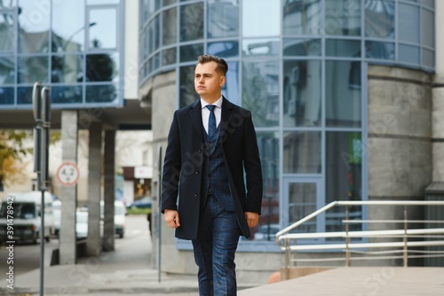 Wallpaper Mural High fashion look.Young stylish confident handsome businessman model in suit clothes walking in the street. Torontodigital.ca