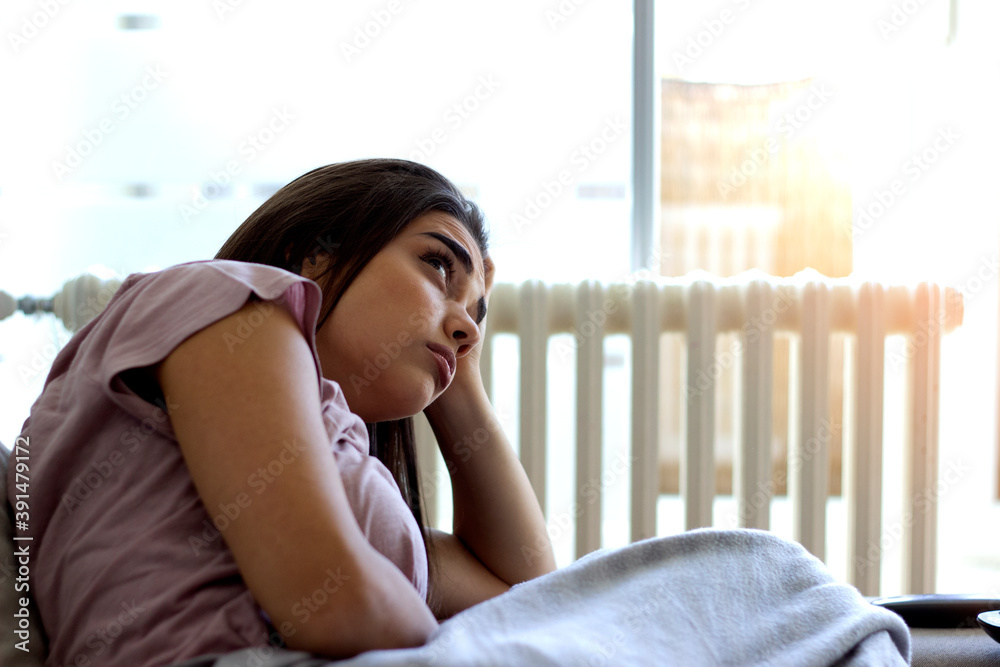 Young hopeless woman suffering from depression.Sad girl sitting alone.Cropped shot of anxious worried woman sitting on couch at home.Frustrated confused female feels unhappy, problems in personal life Young hopeless woman suffering from depression.Sad girl sitting alone.Cropped shot of anxious worried woman sitting on couch at home.Frustrated confused female feels unhappy, problems in personal life