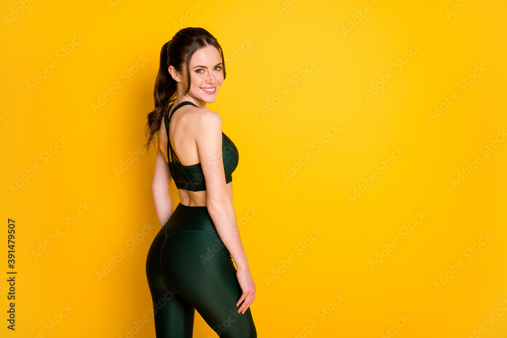 Profile side view portrait of her she nice attractive cheerful sportive girl posing thin figure isolated on bright yellow color background - obrazy, fototapety, plakaty 
