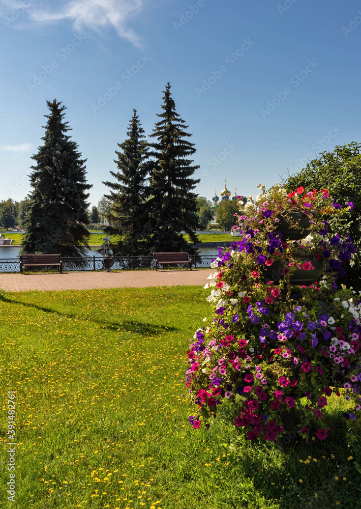 Summer day on the embankment of Afanasy Nikitin. View of the Volga and the old Volga bridge