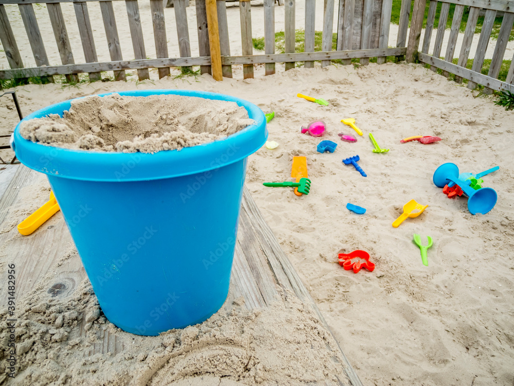 Blue digging bucket in the digging box Blue digging bucket in the digging box