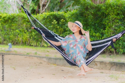 Portrait beautiful young asian woman sit on hammock swing