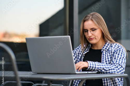 The programmer girl works at the computer	Girls in science. In an empty office during a pandemic.