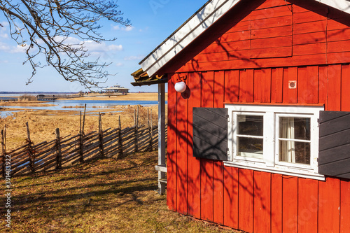 Red cottage by a lake in spring photo