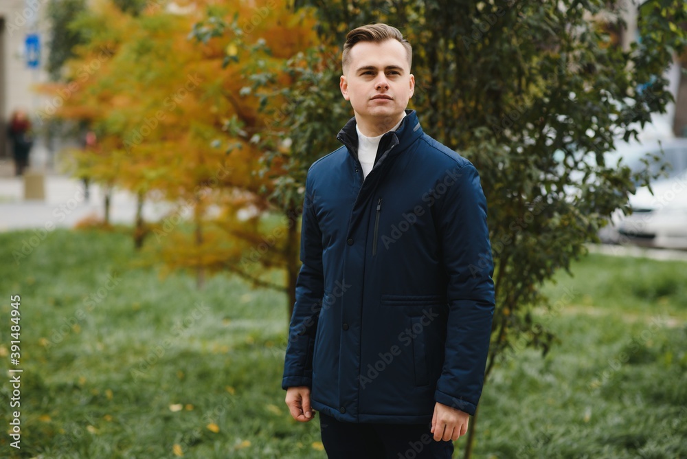 Portrait of a stylish man with a beard dressed in a coat, outdoors Portrait of a stylish man with a beard dressed in a coat, outdoors