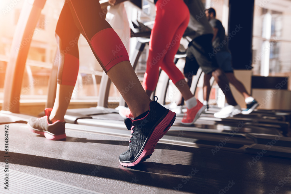People running on a treadmill together at the gym. People running on a treadmill together at the gym.
