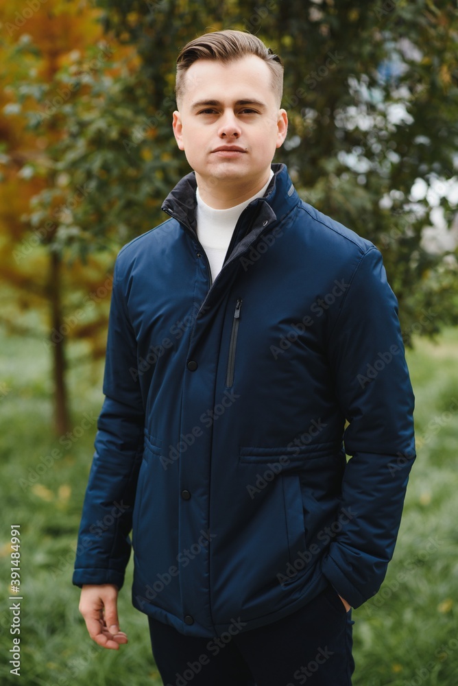 Portrait of a stylish man with a beard dressed in a coat, outdoors Portrait of a stylish man with a beard dressed in a coat, outdoors
