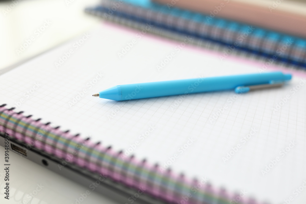 On table is notebook and blue pen. Learning professions remotely concept On table is notebook and blue pen. Learning professions remotely concept