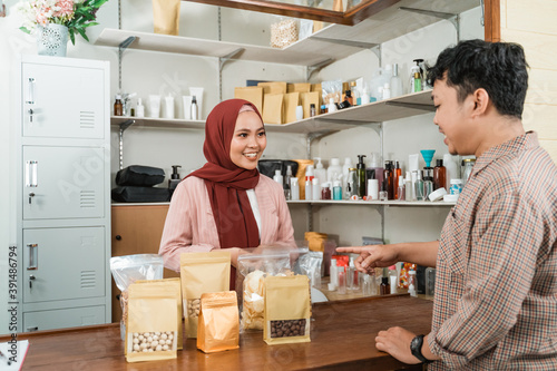 young men buy these packaged products to woman photo