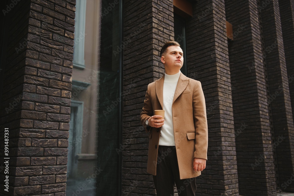 Portrait of a stylish man with a beard dressed in a coat, outdoors Portrait of a stylish man with a beard dressed in a coat, outdoors