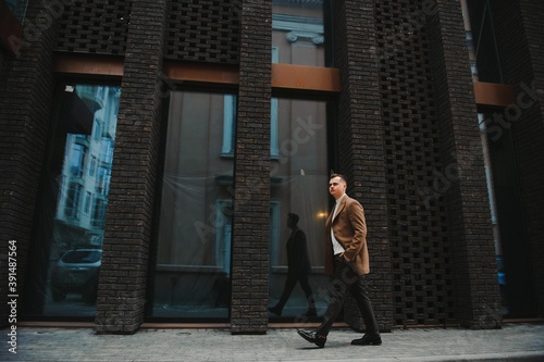 Stylish elegant men man in coat in urban style © Serhii